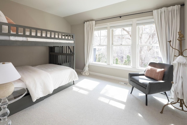 bedroom featuring carpet flooring, vaulted ceiling, and baseboards