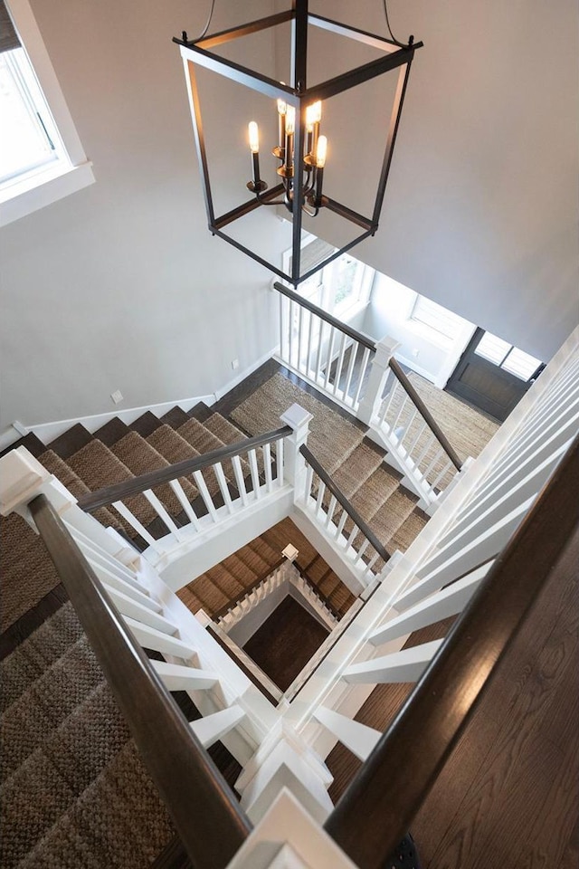 staircase featuring a chandelier