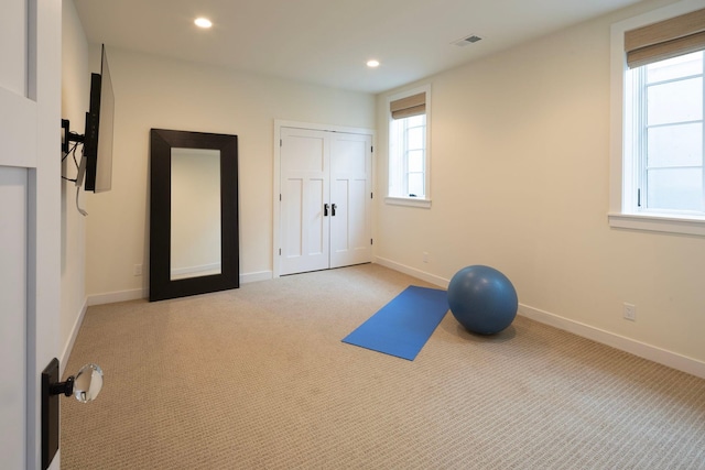 workout room with light carpet, recessed lighting, and baseboards