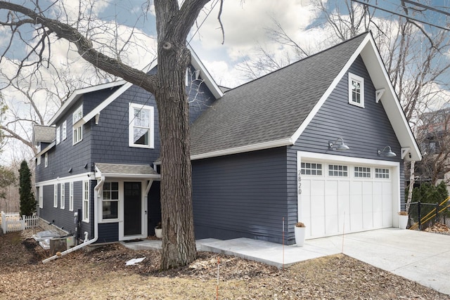 view of front of house featuring a garage, a shingled roof, fence, and concrete driveway
