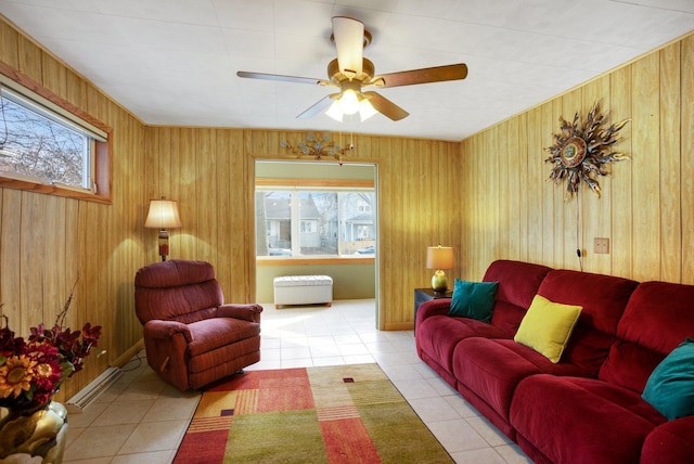 tiled living room featuring wooden walls and ceiling fan