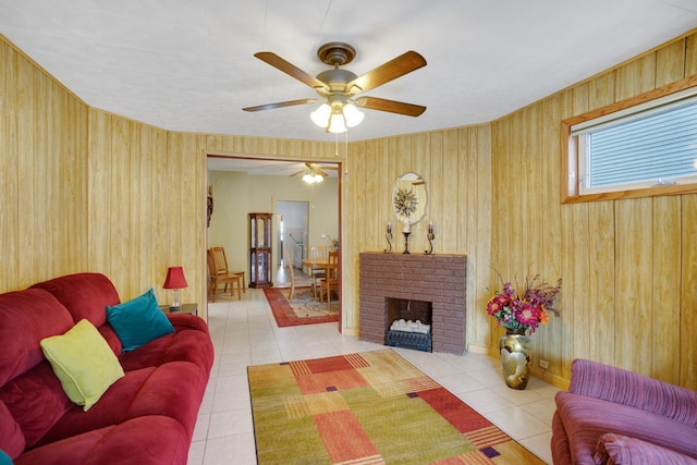 tiled living area featuring a brick fireplace and a ceiling fan