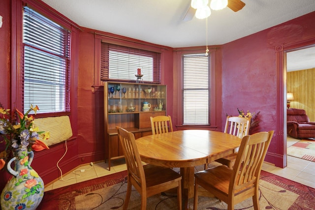 tiled dining space featuring a ceiling fan