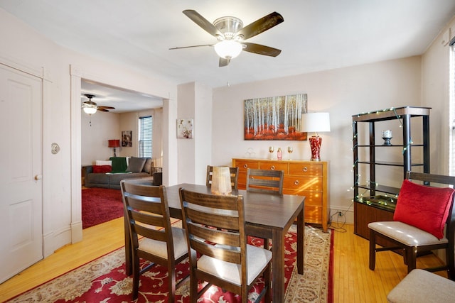 dining room with wood finished floors and ceiling fan