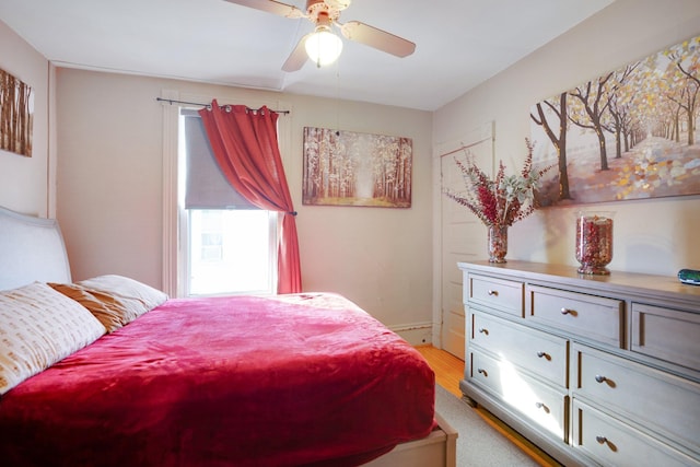 bedroom featuring light wood-style flooring and a ceiling fan