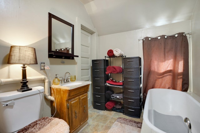 full bathroom featuring vanity, a tub to relax in, vaulted ceiling, curtained shower, and toilet