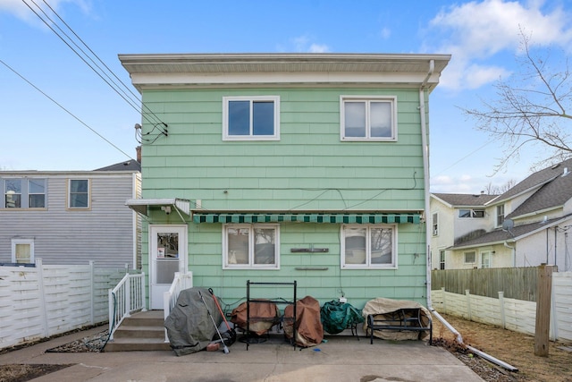 back of house featuring fence