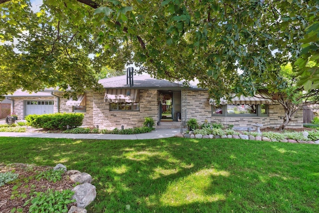 single story home with a garage, a front yard, and stone siding