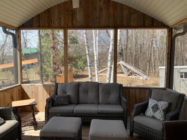 sunroom / solarium featuring lofted ceiling