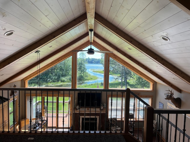 additional living space featuring a wealth of natural light and lofted ceiling with beams