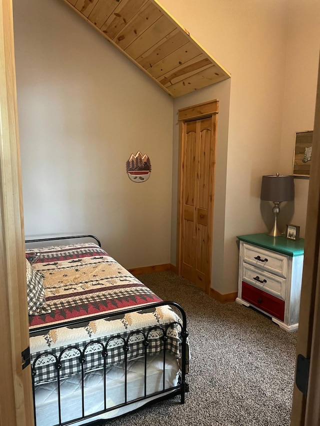 carpeted bedroom with wooden ceiling, baseboards, and vaulted ceiling