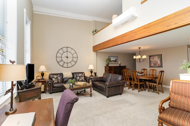 living room featuring beamed ceiling, light colored carpet, a chandelier, and a wall unit AC