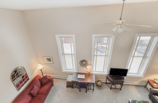 sitting room featuring baseboards, carpet flooring, baseboard heating, and a ceiling fan