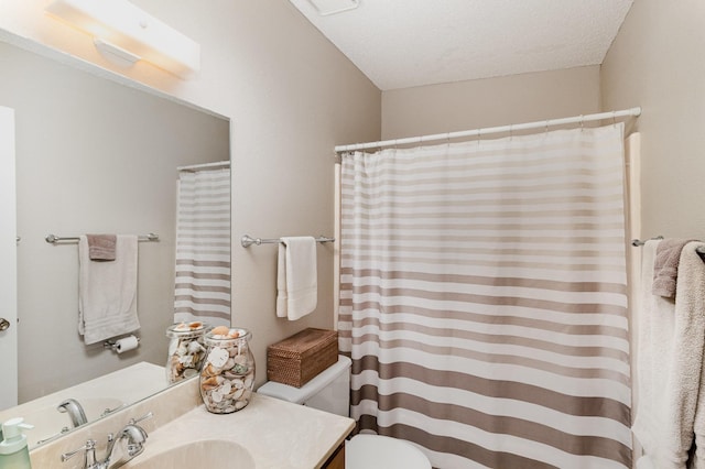 bathroom featuring toilet, vanity, and a shower with shower curtain