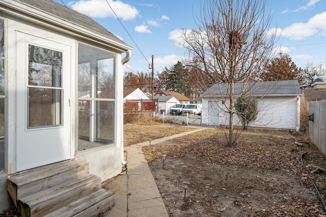 view of yard with entry steps, a sunroom, and fence