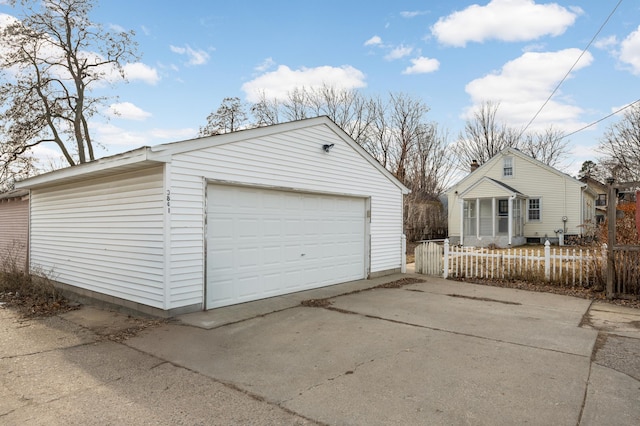 detached garage featuring fence