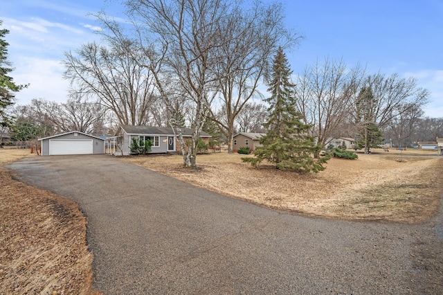 view of front facade featuring a detached garage and an outbuilding