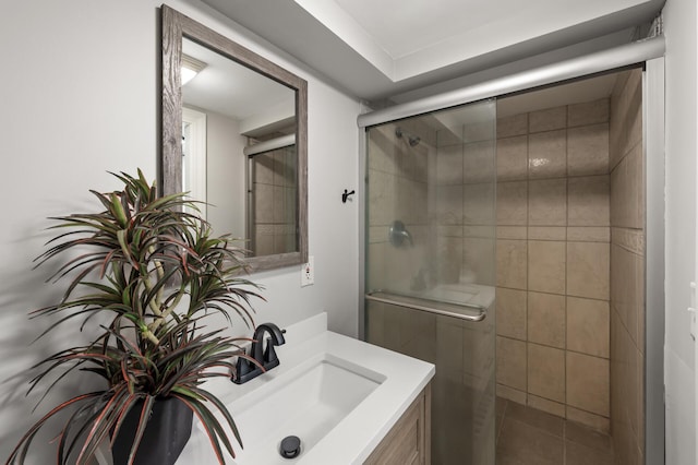 bathroom featuring a stall shower, tile patterned flooring, and vanity