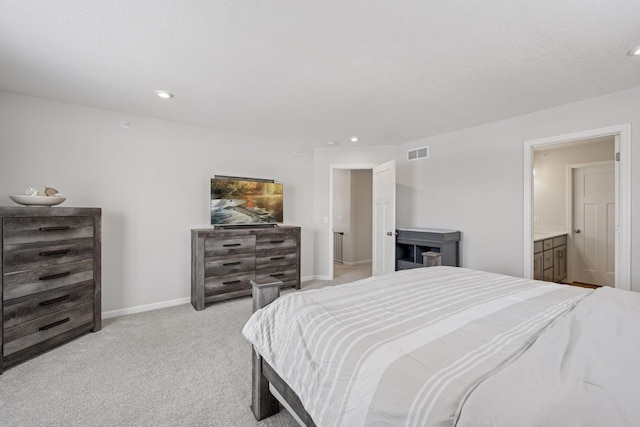 bedroom featuring baseboards, visible vents, ensuite bath, recessed lighting, and light carpet