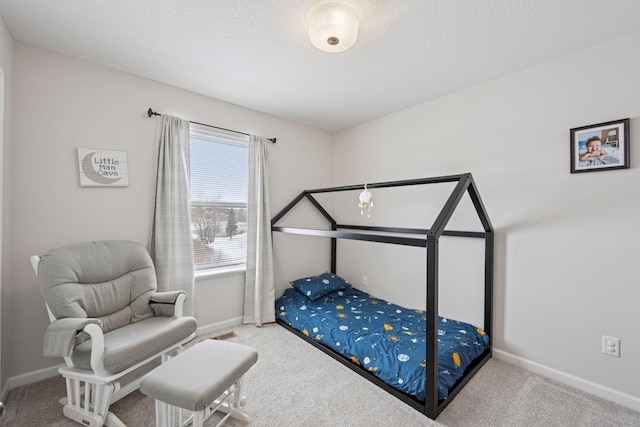 carpeted bedroom with baseboards and a textured ceiling