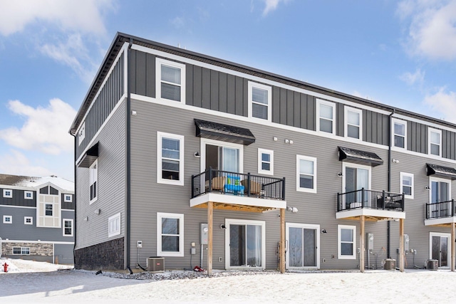 exterior space featuring cooling unit and board and batten siding