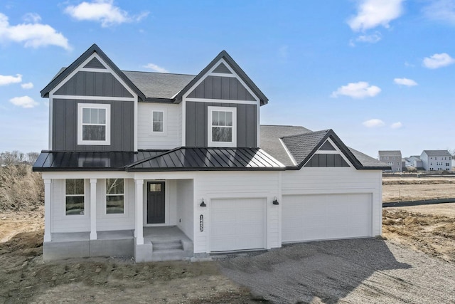 modern farmhouse featuring driveway, metal roof, a standing seam roof, and board and batten siding