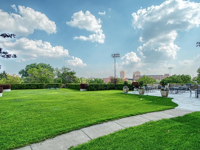 surrounding community featuring a patio area, a yard, and a city view