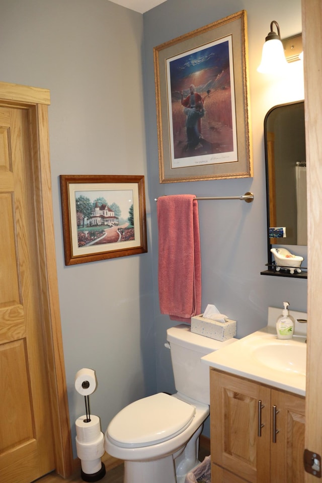 bathroom with toilet and vanity