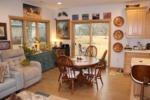 dining area with light wood finished floors, recessed lighting, and baseboards