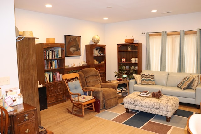 living room with recessed lighting and wood finished floors