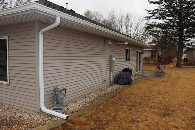 view of side of property with a yard