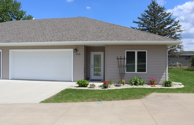 218 Thomas Dr, Rollingstone, MN 55969 - view of front facade featuring driveway, a shingled roof, a garage, and a front lawn