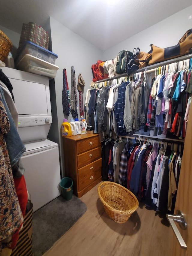 218 Thomas Dr, Rollingstone, MN 55969 - walk in closet featuring stacked washer / dryer and wood finished floors