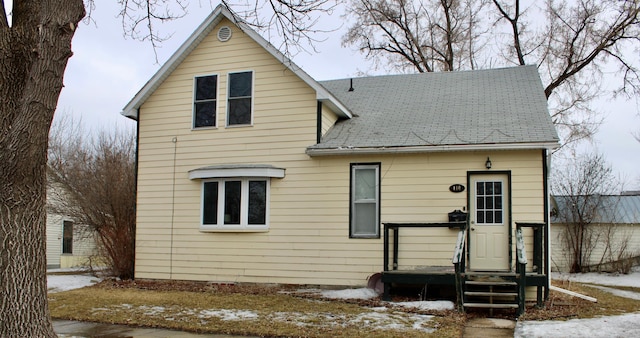 traditional-style house with a shingled roof