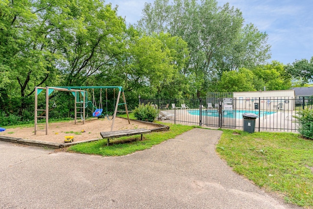 community play area featuring a community pool and fence