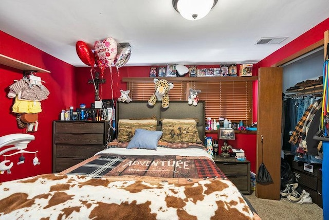 carpeted bedroom featuring visible vents