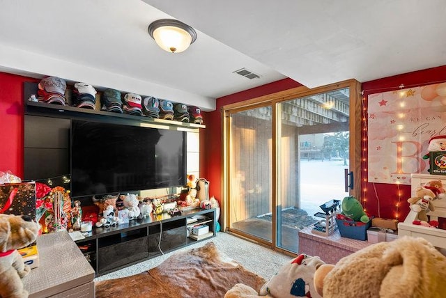 carpeted living area featuring visible vents