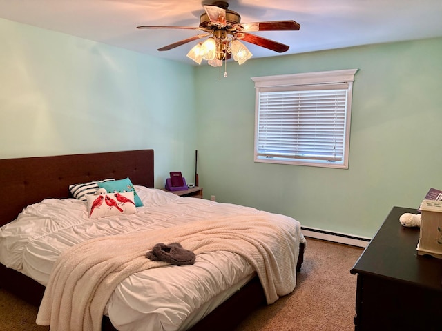 carpeted bedroom featuring a baseboard heating unit and a ceiling fan