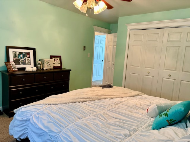 carpeted bedroom with ceiling fan and a closet