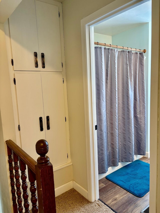 full bathroom with a shower with shower curtain and baseboards