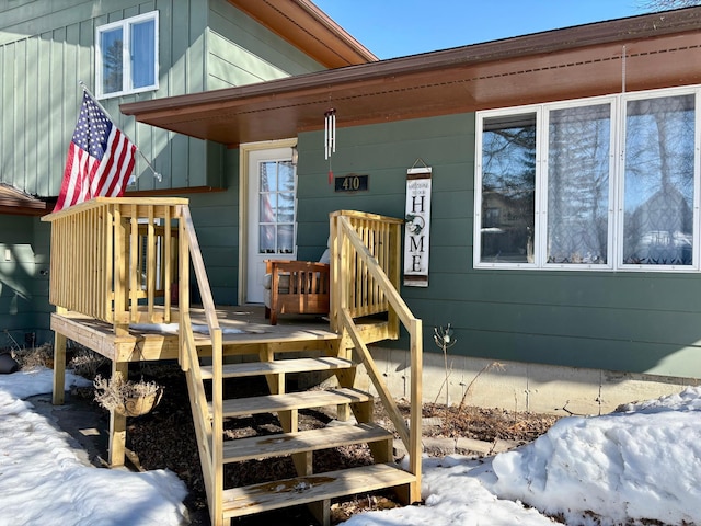 view of snow covered property entrance