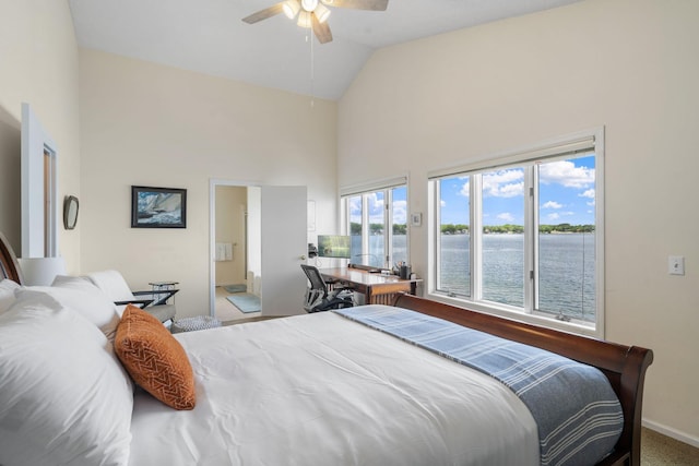 bedroom with a water view, ensuite bathroom, a ceiling fan, high vaulted ceiling, and baseboards