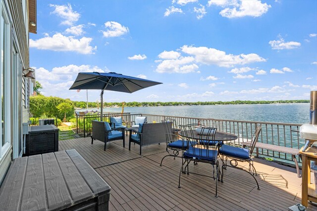 deck with a water view and outdoor lounge area