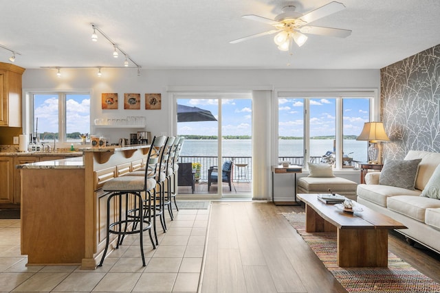 kitchen featuring a kitchen bar, open floor plan, and a wealth of natural light