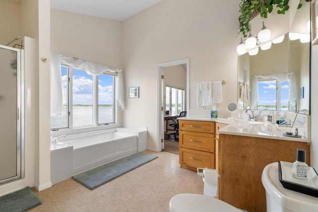 bathroom with toilet, an inviting chandelier, a stall shower, vanity, and a bath