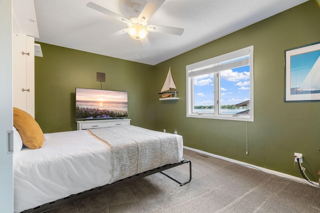 bedroom with ceiling fan, carpet, and baseboards