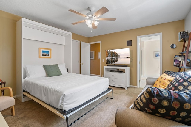 bedroom featuring light colored carpet, ceiling fan, and baseboards