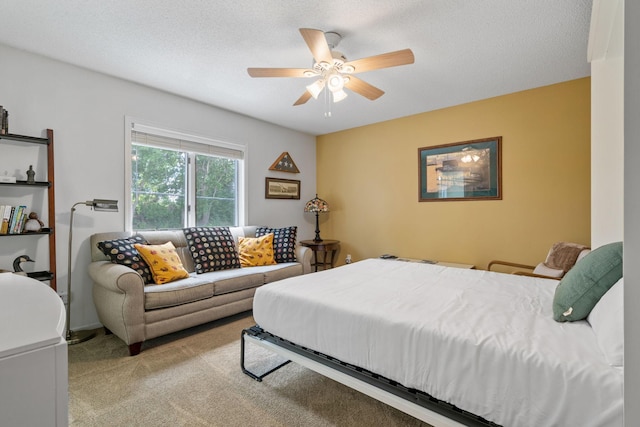 carpeted bedroom with a ceiling fan and a textured ceiling