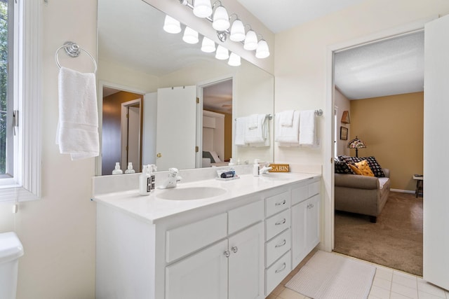 bathroom featuring double vanity, a sink, and ensuite bathroom