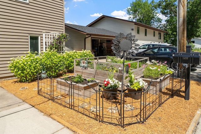 exterior space featuring a shingled roof and a vegetable garden